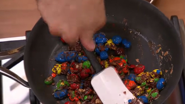 Contestant cooking pasta with candy 