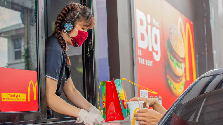 woman handing food to customer