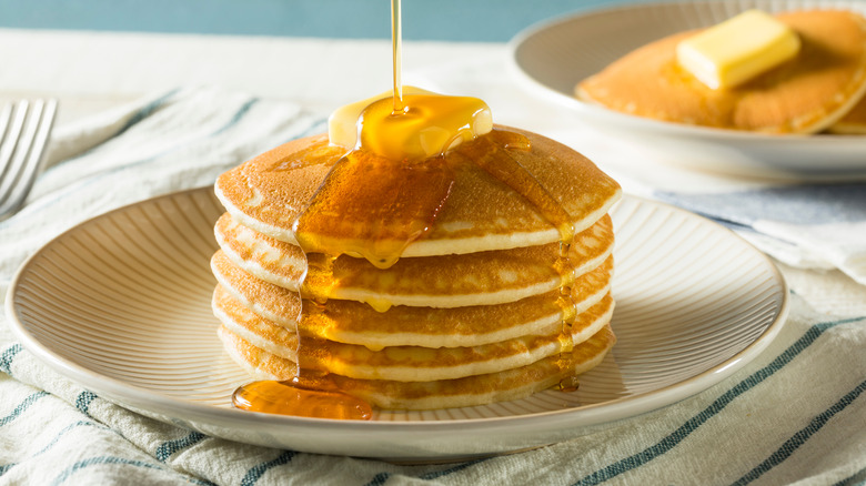 Stack of pancakes with butter and syrup