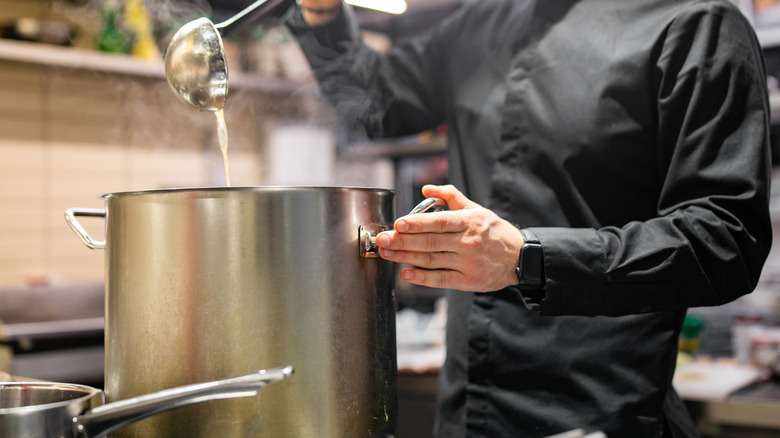 Chef pouring soup