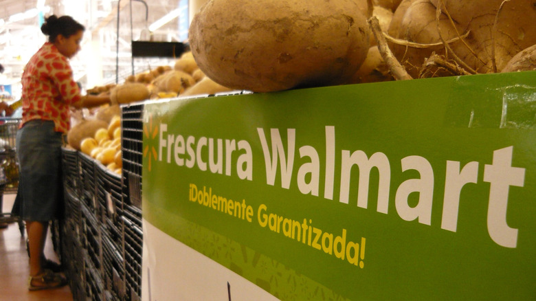 Woman in Walmart next to sign