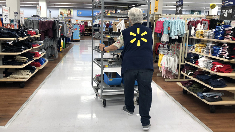 Walmart worker pushing trolley