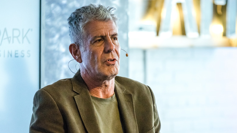 Anthony Bourdain speaking into headset