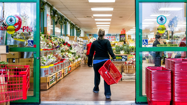 woman walking into trader joes