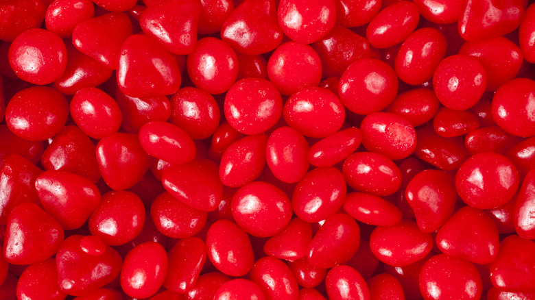 Handfuls of Red Hot candies 