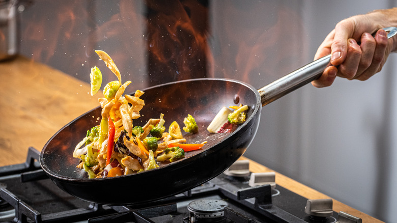 Pan with veggies over flame