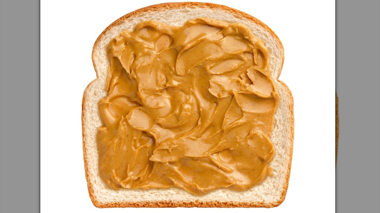 Overhead view of peanut butter on sliced bread