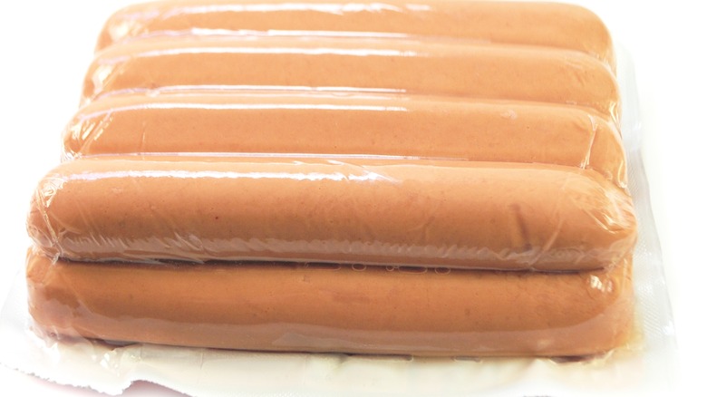 Pre-packaged hot dogs on white background