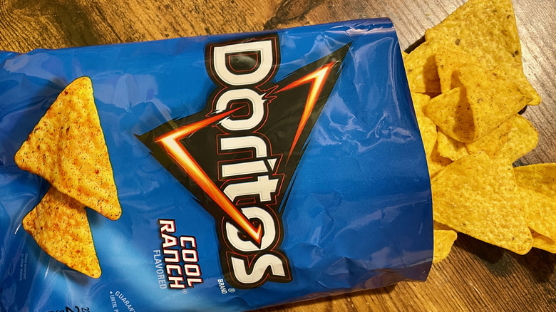 An open bag of Cool Ranch Doritos and chips