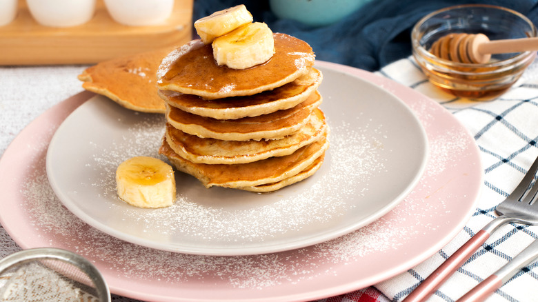 Stacked pancakes topped with bananas