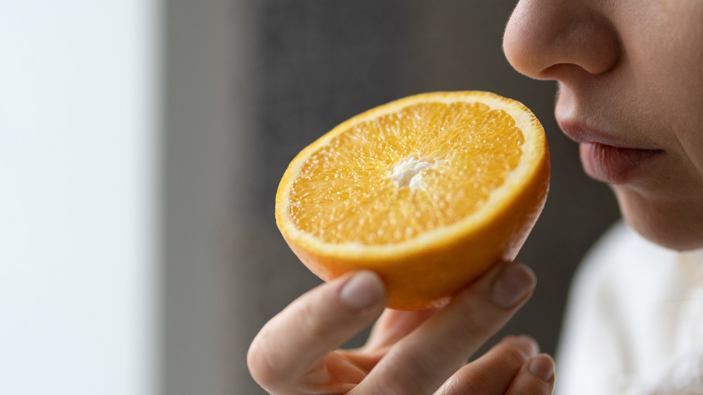 Nose smelling an orange