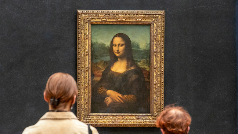 People observe the Mona Lisa painting