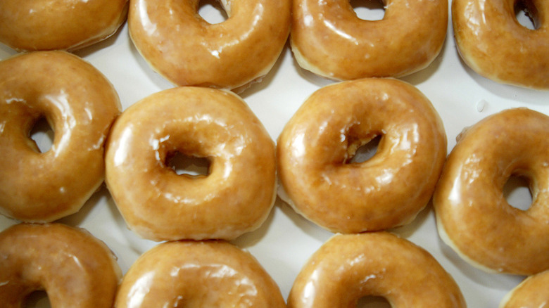 Rows of glazed plain donuts