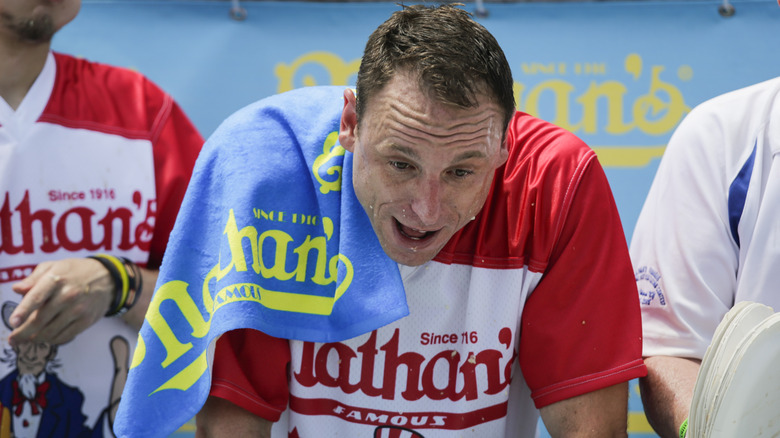 Joey Chestnut during competition with Nathan's towel