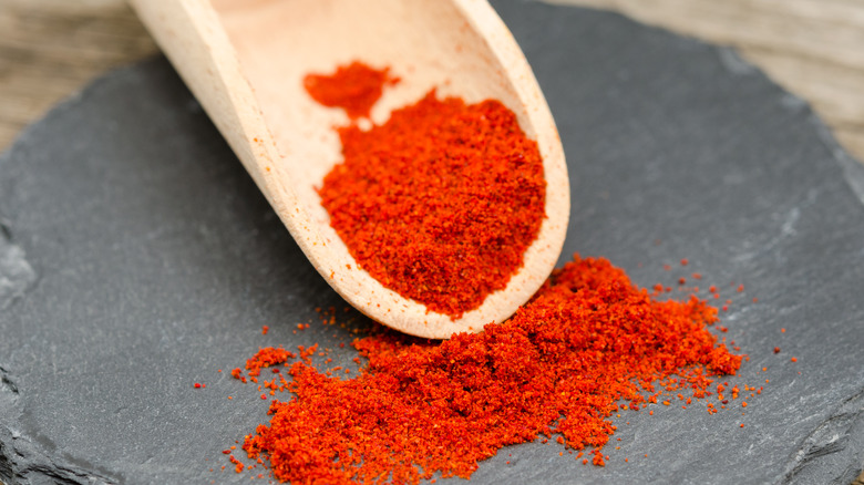 Paprika on a small wooden scoop