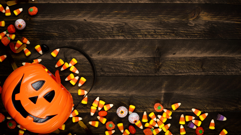 Pumpkin bucket with candy corn spilling out