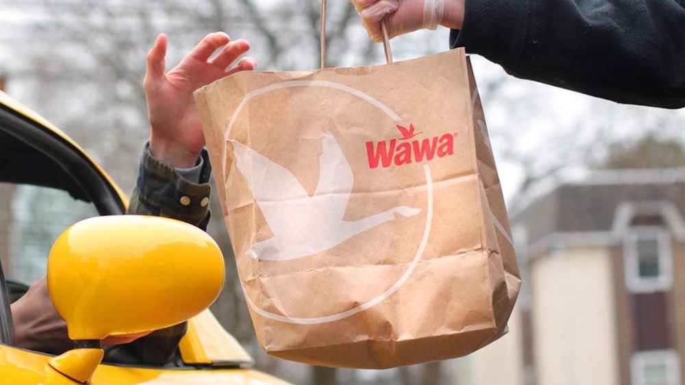 Person handing Wawa bag to another