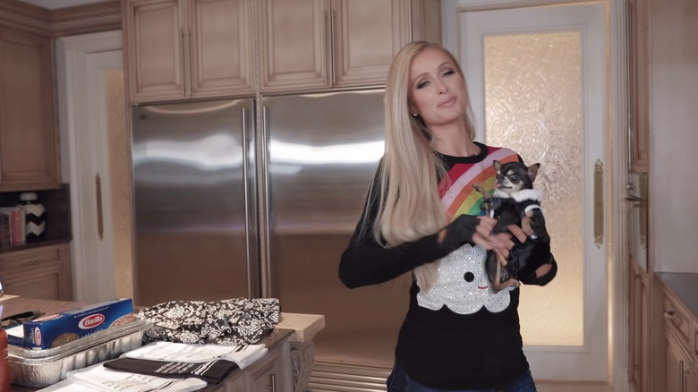 Paris Hilton in a kitchen with her dog