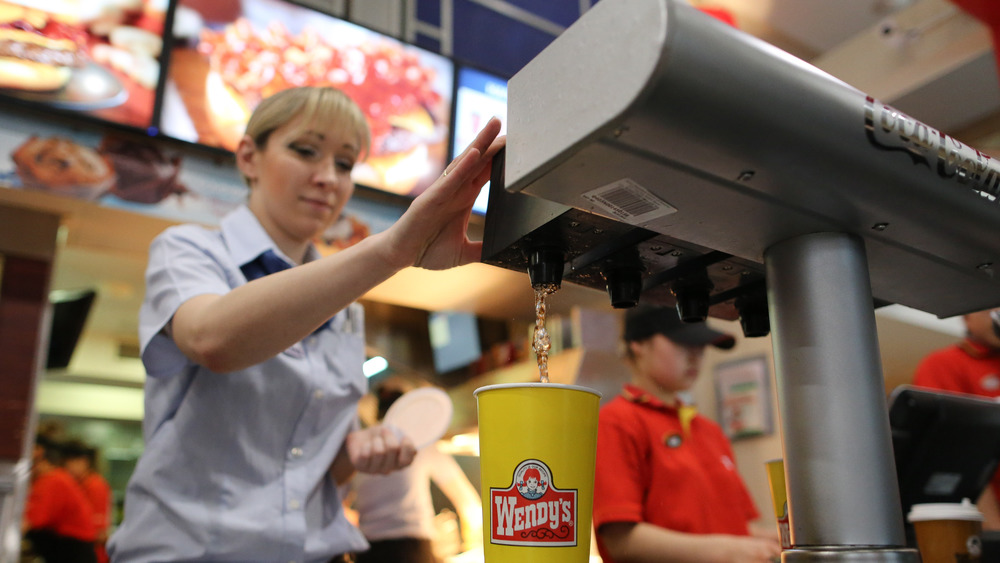 wendy's worker preparing drink 