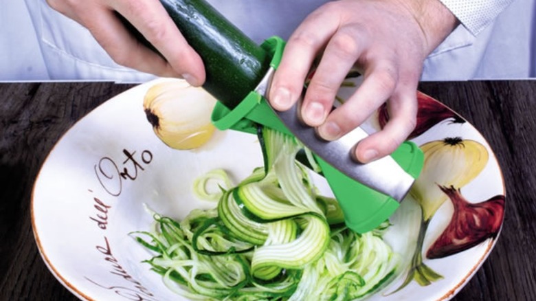 Person using vegetable spiralizer