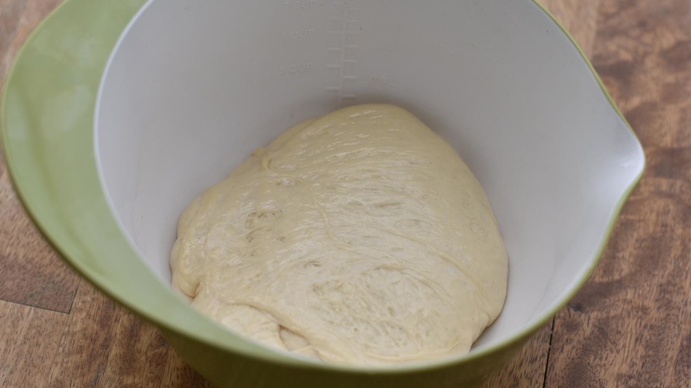 Pizza dough rising in a bowl
