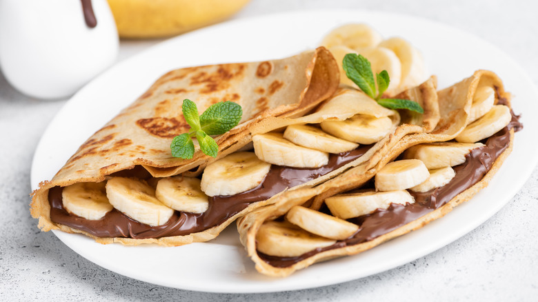 crepes with nutella and banana filling, topped with mint