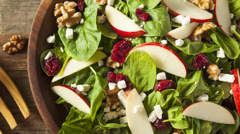 bowl of salad craisins apples spinach walnuts