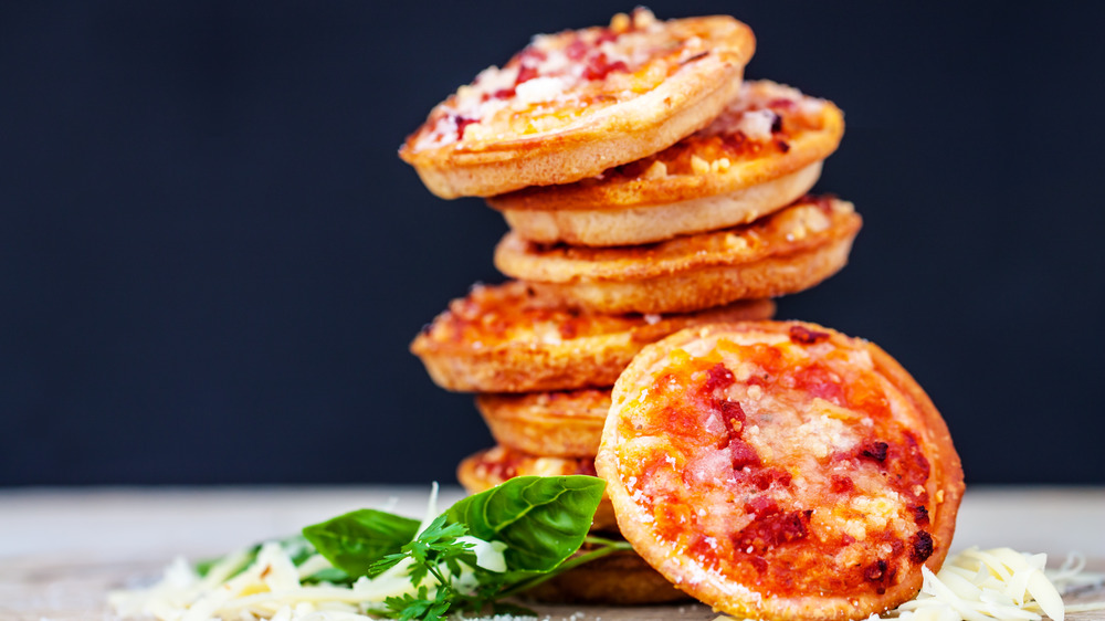 Stacked mini pizzas on table