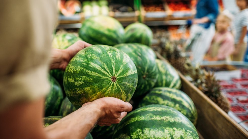 Woman buying watermelon