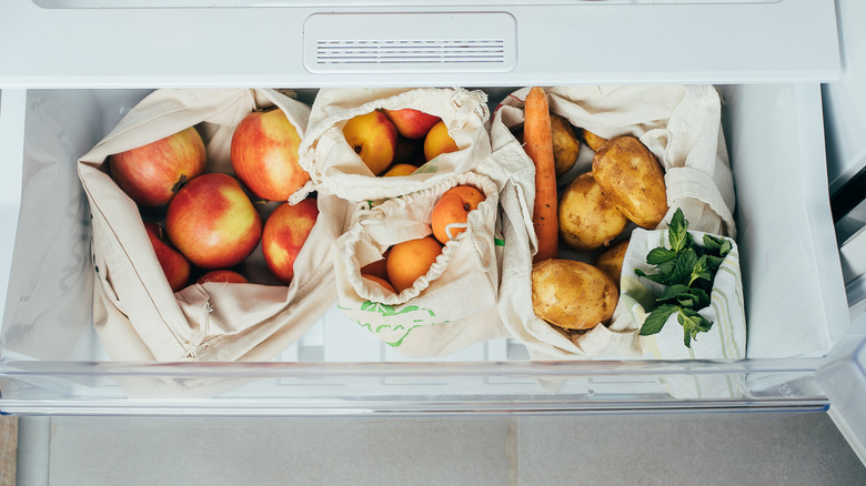 Apples, potatoes, and carrots in bags