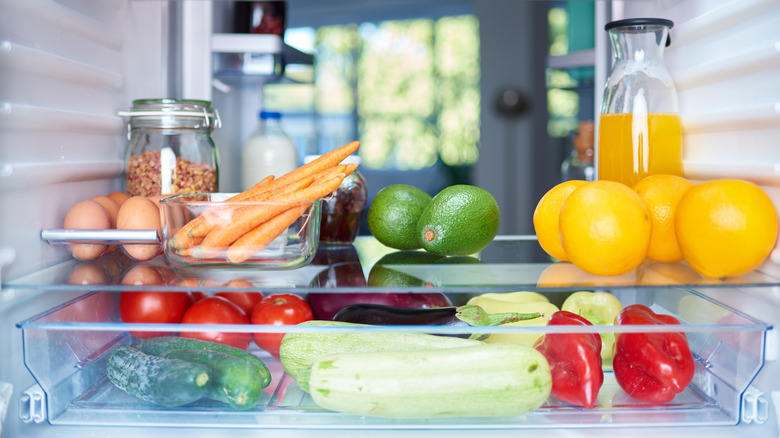 Peppers, cucumbers, avocados, carrots, in refrigerator