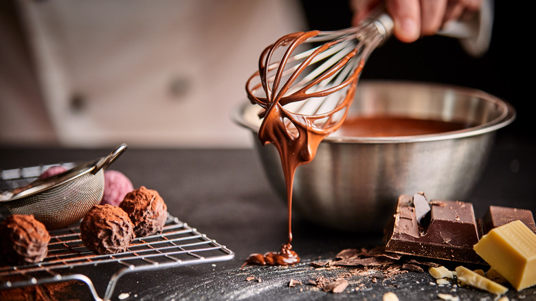 A whisk covered in chocolate