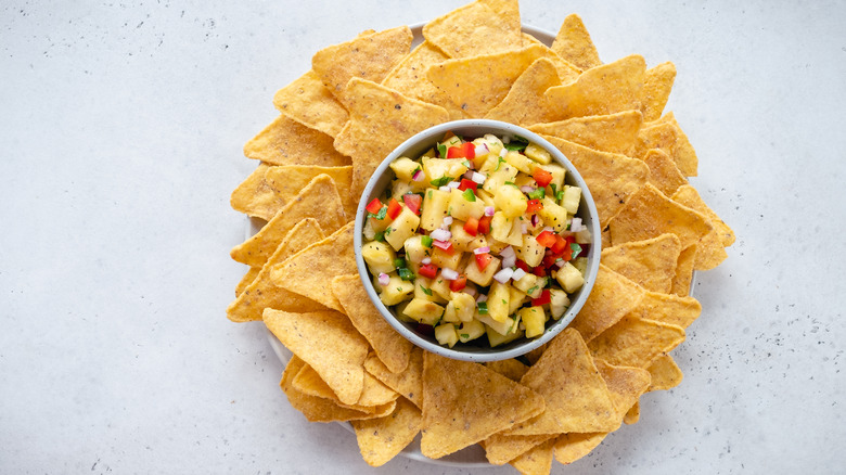 Tortilla chips surrounding bowl of salsa