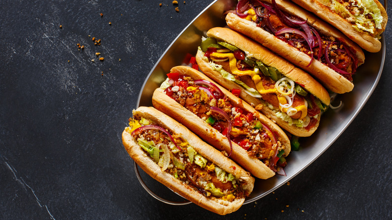 Bunch of hot dogs with assorted toppings