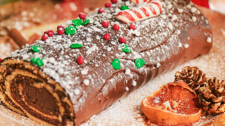 Festive Yule log cake with chocolate frosting