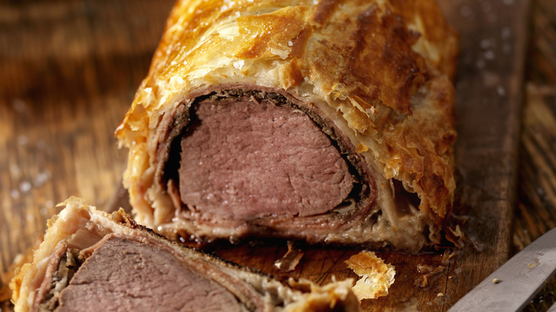 Sliced beef Wellington on cutting board