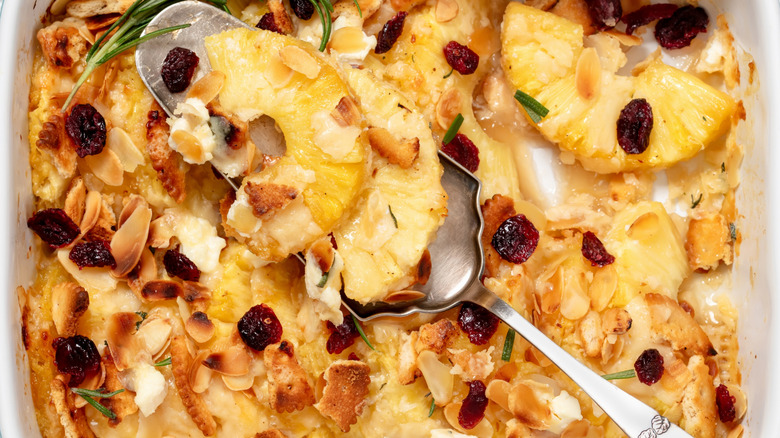 Overhead view of pineapple casserole with serving spoon