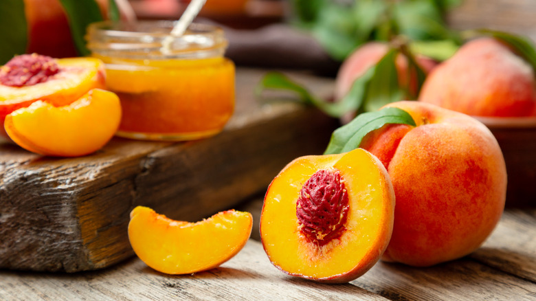 A selection of sliced and whole peaches and jam on display