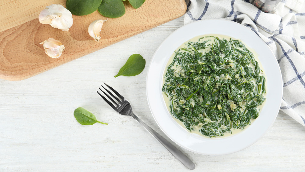 creamed spinach in white bowl 