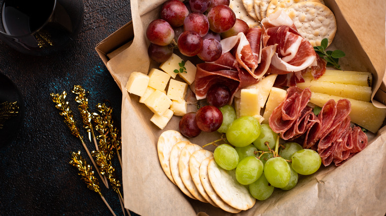 Charcuterie board with grapes, cheese, and crackers