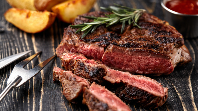 a medium-rare steak with potatoes