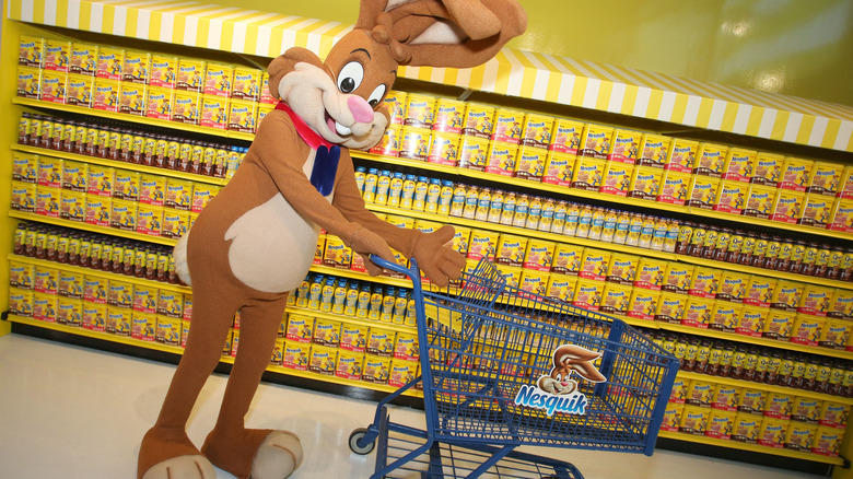 Costumed Quicky character shopping in an aisle full of Nesquik products