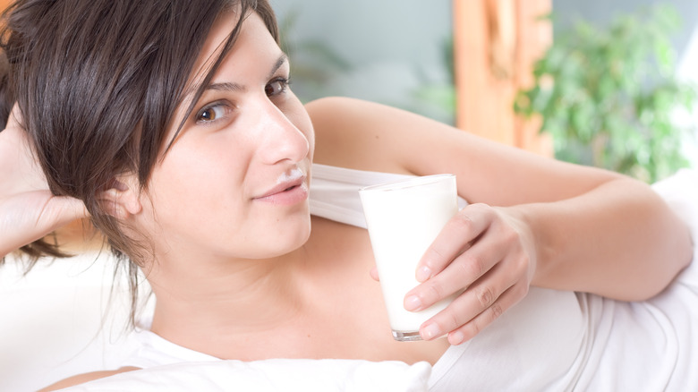 woman staring sultrily holding milk