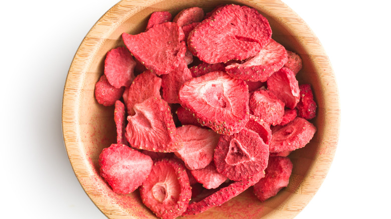 Dried strawberries on pink background