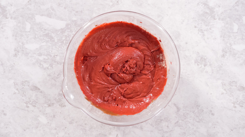 Red velvet cake batter in clear bowl