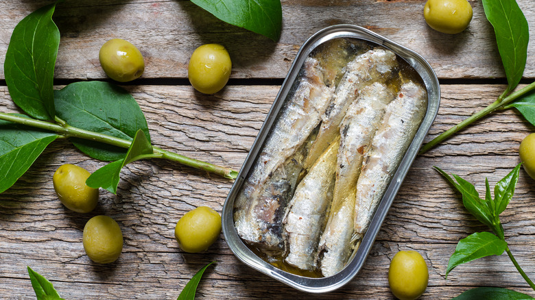 open can of sardines with olives