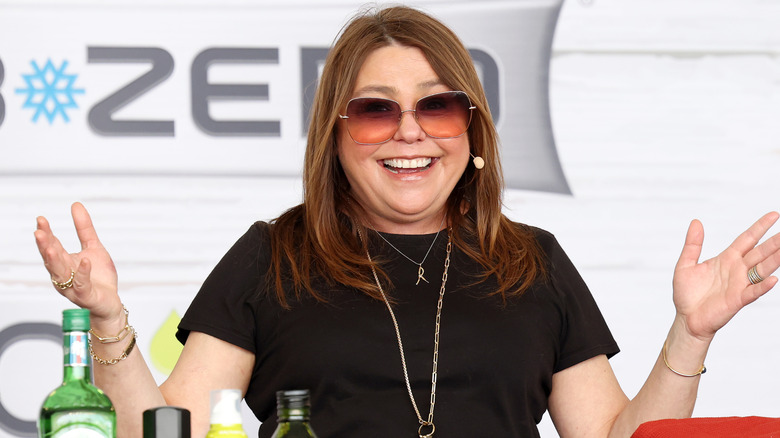 Rachael Ray in sunglasses with hands up