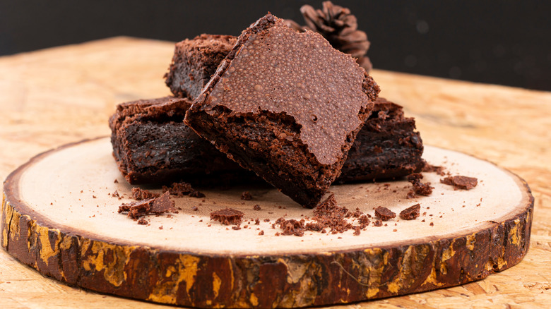 chocolate brownies stacked on board