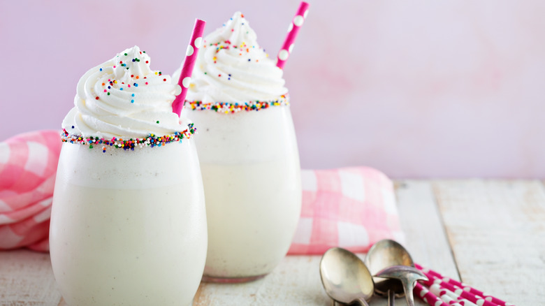 funfetti milkshakes topped with whipped cream and sprinkles