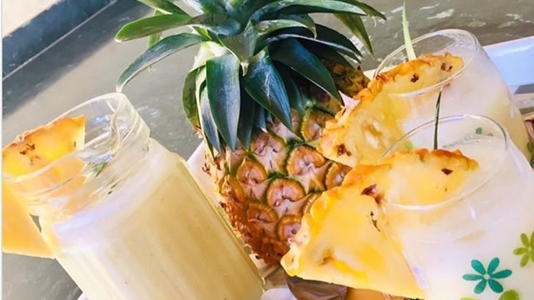 pineapple milkshakes garnished with pineapple wedges